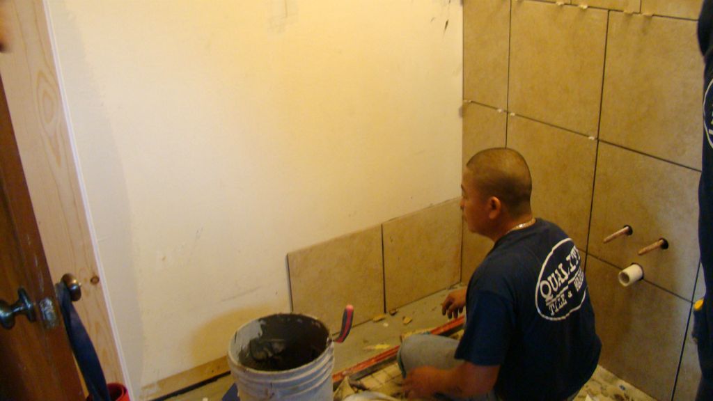 New floor and wall tile being installed